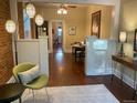 Cozy living room featuring hardwood floors, exposed brick, and stylish decor at 3616 N Gilpin St, Denver, CO 80205