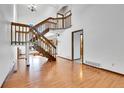Bright foyer with hardwood floors, grand staircase, and natural light at 13270 W 65Th Ave, Arvada, CO 80004