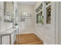 Bright entryway with hardwood floors, stylish console table, and decorative wallpaper at 549 N Ogden St, Denver, CO 80218