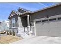 Charming house featuring neutral siding, stone accents, well-manicured yard, and a two-car garage at 9694 Truckee St, Commerce City, CO 80022