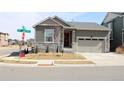 Attractive home with stone accents, landscaping, and a convenient two-car garage at 9694 Truckee St, Commerce City, CO 80022