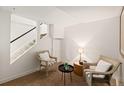 Cozy sitting area with staircase, two chairs, and a small table with a lamp at 1120 N Clarkson St # 6, Denver, CO 80218