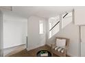 Comfortable sitting area featuring a chair, small table, and view of the staircase at 1120 N Clarkson St # 6, Denver, CO 80218