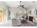 Comfortable living room with fireplace, ceiling fan, large sofa, and a sliding glass door at 9804 Martin Luther King Blvd, Denver, CO 80238