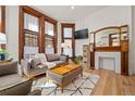 Stylish living room featuring hardwood floors, large windows, and a decorative fireplace at 1763 N Williams St # 101, Denver, CO 80218
