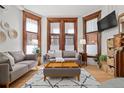 Inviting living room with hardwood floors, large windows, and comfortable seating at 1763 N Williams St # 101, Denver, CO 80218
