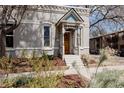Charming home with a welcoming front porch, beautifully landscaped yard, and unique architectural features at 2841 W 27Th Ave, Denver, CO 80211