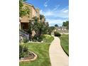 The property boasts lush green lawns, mature trees, and meticulously landscaped areas, enhancing the townhome's appeal at 13187 E Bethany Pl, Aurora, CO 80014