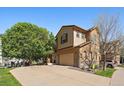 Charming two-story home features a spacious driveway, well-kept lawn, and appealing exterior paint scheme at 11811 E Maplewood Ave, Englewood, CO 80111