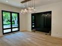 Spacious dining room with large window and elegant light fixture at 2442 S Saint Paul St, Denver, CO 80210