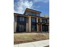 Modern two-story home with black trim, brick accents and unfinished landscaping at 2442 S Saint Paul St, Denver, CO 80210