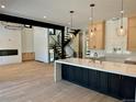 Bright, open kitchen boasts a quartz island, pendant lighting, and stainless steel appliances at 2442 S Saint Paul St, Denver, CO 80210