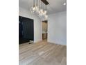 Open living room with hardwood floors, modern lighting, and glass doors at 2442 S Saint Paul St, Denver, CO 80210