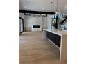 Open living room with hardwood floors, modern lighting, and staircase at 2442 S Saint Paul St, Denver, CO 80210