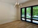Light filled living room with beautiful light fixture and expansive windows at 2442 S Saint Paul St, Denver, CO 80210