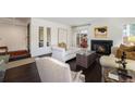 Cozy living room with hardwood floors, a fireplace, and comfortable seating arrangements at 1050 S Monaco Pkwy # 35, Denver, CO 80224