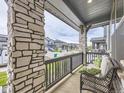 A comfortable porch setting with a bench and stone pillars, offering a relaxing outdoor view at 2967 S Quaker St, Morrison, CO 80465