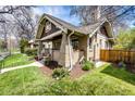 Brick home with a well-manicured lawn and mature landscaping creating a peaceful outdoor space at 780 N Franklin St, Denver, CO 80218