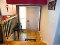 Inviting entryway with tile floors, modern decor, and stairs leading to upper level at 1936 S Poplar St, Denver, CO 80224