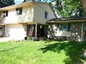 Charming two-story home with well-manicured lawn, brick accents, and attached garage at 1936 S Poplar St, Denver, CO 80224