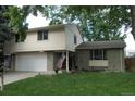Well-maintained two-story house with a two-car garage and a lush green lawn at 1936 S Poplar St, Denver, CO 80224
