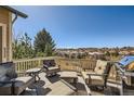 Relax on this deck featuring comfortable seating and a gas grill, perfect for outdoor entertaining at 7009 Winter Ridge Pl, Castle Pines, CO 80108