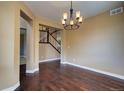 Dining room showcasing hardwood floors, stylish chandelier, and views of the staircase at 25994 E Peakview Pl, Aurora, CO 80016