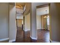 Elegant foyer featuring hardwood floors, staircase, and well-lit dining area at 25994 E Peakview Pl, Aurora, CO 80016