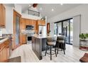 Bright and modern kitchen with stainless steel appliances, center island, and sliding glass doors at 5166 Bear Mountain Dr, Evergreen, CO 80439