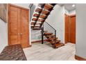 Modern staircase with wooden steps, metal railings, and stylish lighting at 5166 Bear Mountain Dr, Evergreen, CO 80439