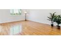 Bright living room with hardwood floors, large window, and minimalist decor, bathed in natural light at 7158 W Roxbury Ave, Littleton, CO 80128