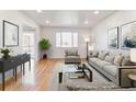 Inviting living room features hardwood floors, neutral-toned furniture, and stylish decor, creating a cozy atmosphere at 7158 W Roxbury Ave, Littleton, CO 80128