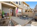 Inviting front porch with seating area and American flag offers a warm welcome at 17922 E 104Th Pl # D, Commerce City, CO 80022