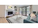Inviting living room featuring a stone fireplace, stylish decor, and access to balcony at 3363 Oneal Pkwy # 36, Boulder, CO 80301