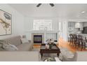 Bright living room with a fireplace, hardwood floors, and an open layout leading to the kitchen at 8073 S Albion St, Centennial, CO 80122