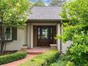 Inviting front entrance with double doors, sidelights, potted plants, and a red brick path at 3975 S Cherry St, Cherry Hills Village, CO 80113