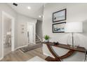 Inviting entryway with wood floors, decorative table, and art on the wall at 16762 Tejon Ln, Broomfield, CO 80023