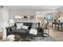 Modern living area with comfortable sofa, open kitchen view, and chic decor at 7700 W Glasgow Pl # 10A, Littleton, CO 80128