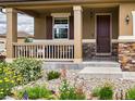Inviting front porch features detailed railing, stone accents, and manicured landscaping enhancing the home's curb appeal at 784 Sweet Pine Ct, Monument, CO 80132