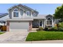 Charming two-story home featuring an attached garage, a manicured lawn, and beautiful landscaping at 20789 E Princeton Pl, Aurora, CO 80013
