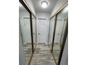 Hallway with mirrored closet doors and wood-look flooring at 12652 E Warren Dr # C, Aurora, CO 80014