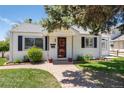 Charming single-story home with a brick walkway, green lawn, and mature landscaping at 4197 S Grant St, Englewood, CO 80113