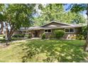 Inviting single-Gathering home featuring mature trees, lush lawn, and a quaint lamp post along the walkway at 2934 S Columbine St, Denver, CO 80210