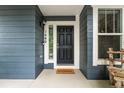 Close-up of the front door with a 'welcome' mat and stylish exterior details at 1480 Sterling Hill Ct, Castle Rock, CO 80104
