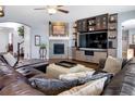 Comfortable living room featuring a fireplace, built-in shelves, and plush leather seating at 3385 Birch Rd, Longmont, CO 80504