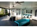 Inviting covered patio with comfortable seating, ceiling fans, and views of the outdoor landscape at 8659 E Kenyon Ave, Denver, CO 80237