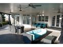 Inviting covered patio with comfortable seating, ceiling fans, and views of the outdoor landscape at 8659 E Kenyon Ave, Denver, CO 80237
