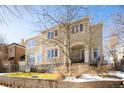 Beige two-story home with large windows and a manicured lawn at 335 Josephine St # A, Denver, CO 80206