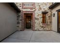 Close-up of the front door featuring stone and brick detailing at 8246 Raphael Ln, Littleton, CO 80125