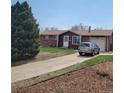 Well-maintained home with a long driveway and attached garage at 9008 Dover St, Broomfield, CO 80021